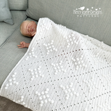 Baby under a bobble stitch blanket